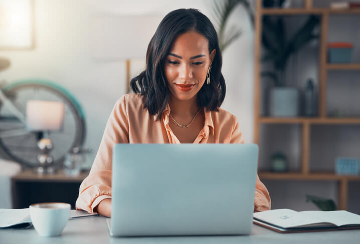 Person sitting at a desk typing on a laptop