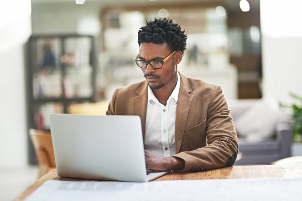 Person typing at computer in office setting.