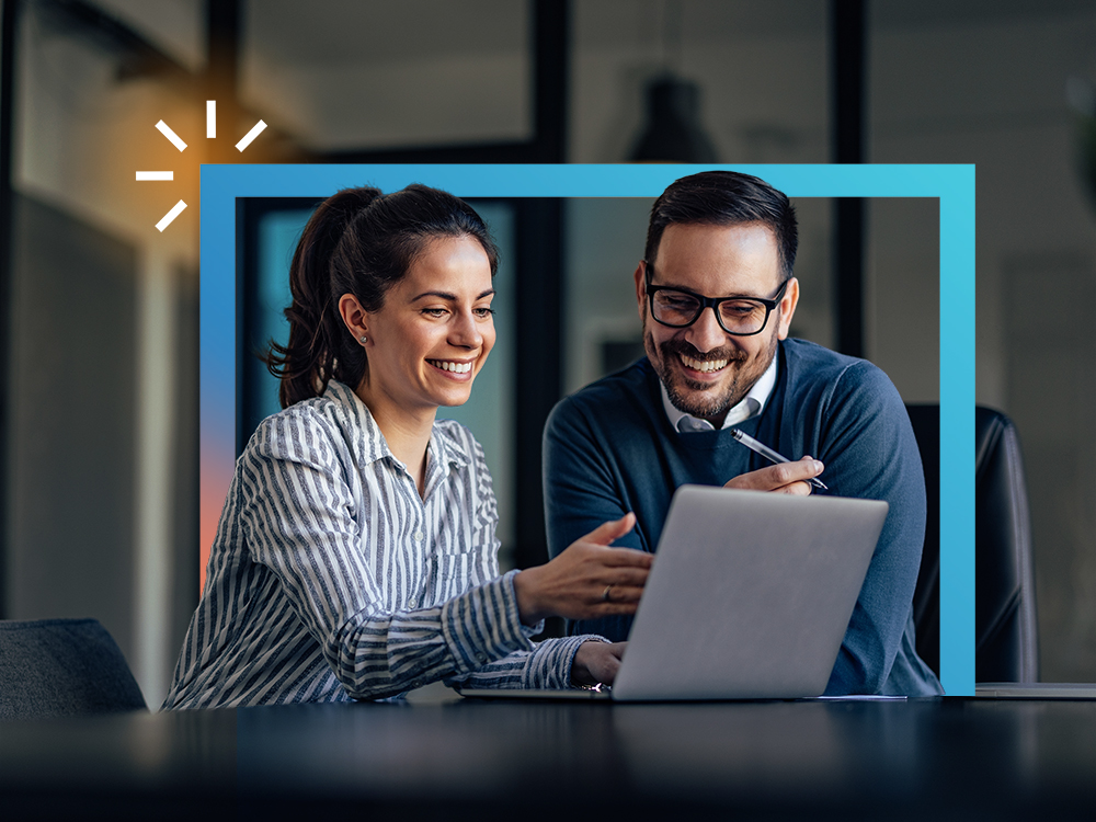 Two people smiling at a laptop, with blue rectangle and white icon overlay.